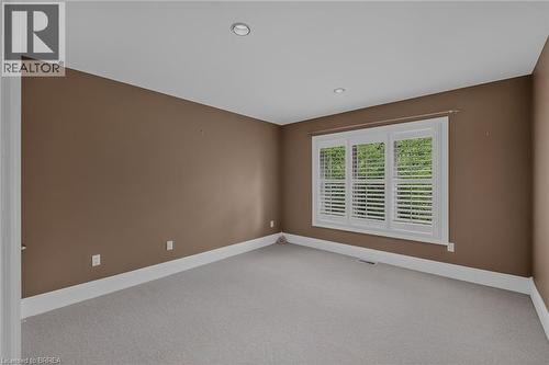 Room featuring a window with white louvered shutters, recessed lighting, wall-to-wall carpeting, and baseboard trim - 44 St Andrew'S Drive, Brantford, ON - Indoor Photo Showing Other Room