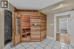 Dedicated sauna room with wood paneling and interior bench seating - 