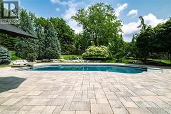 Expansive pool deck featuring paver stone surfacing - 