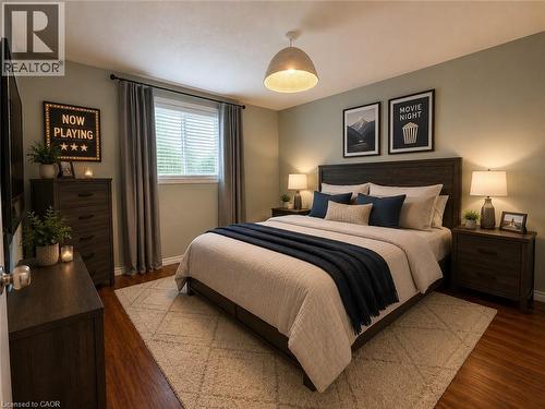 Spacious bedroom featuring wood-finish flooring, a contemporary ceiling light fixture, and a window with blinds - 41 Edgemere Drive, Cambridge, ON - Indoor Photo Showing Bedroom