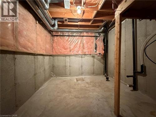 Unfinished basement space featuring exposed concrete walls and flooring - 41 Edgemere Drive, Cambridge, ON - Indoor Photo Showing Basement