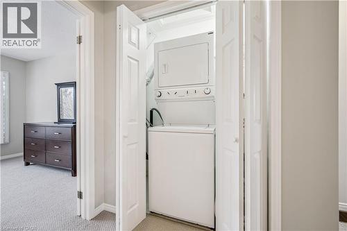 Dedicated laundry closet featuring a stacked washer and dryer - 711 Johnston Park Avenue, Collingwood, ON - Indoor Photo Showing Laundry Room