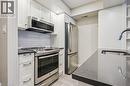 Kitchen featuring white shaker cabinetry, stainless steel appliances, dark countertops, a white subway tile backsplash, and recessed lighting - 711 Johnston Park Avenue, Collingwood, ON  - Indoor Photo Showing Kitchen With Upgraded Kitchen 