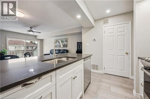 Kitchen island featuring a double basin stainless steel sink with a gooseneck faucet - 711 Johnston Park Avenue, Collingwood, ON - Indoor Photo Showing Kitchen With Double Sink