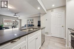 Kitchen island featuring a double basin stainless steel sink with a gooseneck faucet - 