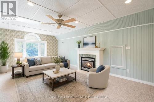 Virtually Staged - 105 Copeland Creek Drive, Tiny, ON - Indoor Photo Showing Living Room With Fireplace