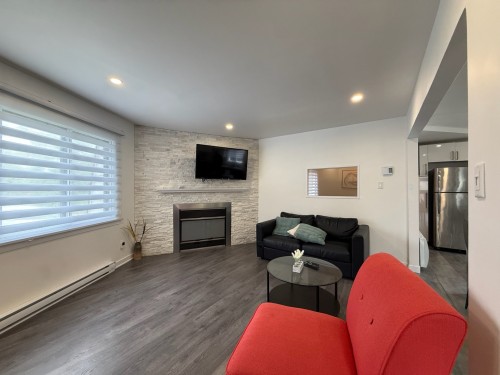 Salon - 299 Rue De La Reine, Laval (Auteuil), QC - Indoor Photo Showing Living Room With Fireplace