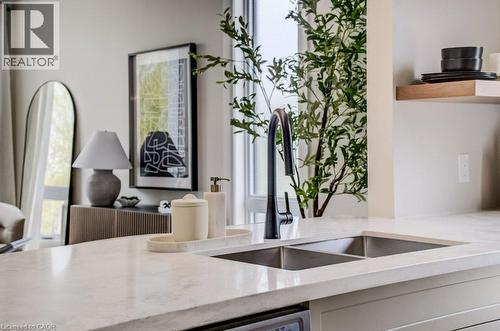 Dual-basin stainless steel sink with a matte black faucet set into a light-toned countertop - 210 Heritage Drive Unit# Upper, Kitchener, ON - Indoor Photo Showing Kitchen With Double Sink
