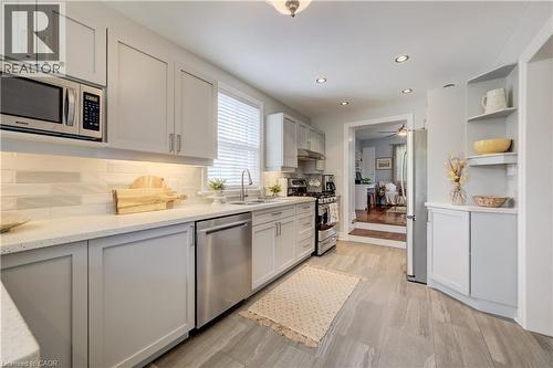 Kitchen featuring light gray cabinetry, stainless steel appliances, white countertops, and a subway tile backsplash - 314 Glasgow Street, Kitchener, ON - Indoor Photo Showing Kitchen