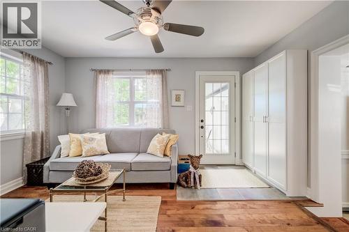 Living area featuring wood-finish flooring, light grey wall paint, and a ceiling fan with integrated lighting - 314 Glasgow Street, Kitchener, ON - Indoor Photo Showing Living Room