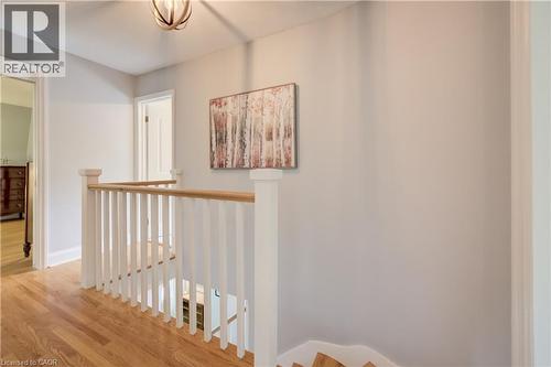 Upper-level landing featuring hardwood flooring and a white wooden staircase with a natural wood handrail - 314 Glasgow Street, Kitchener, ON - Indoor Photo Showing Other Room