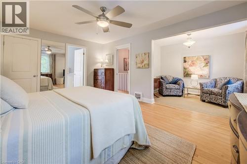 Bedroom featuring wood-finish flooring, ceiling fan with integrated lighting, and direct access to an additional living space - 314 Glasgow Street, Kitchener, ON - Indoor Photo Showing Bedroom