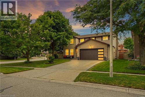 Brick and stucco exterior with a modern garage door featuring frosted glass panels - 19 Alona Avenue, Cambridge, ON - Outdoor