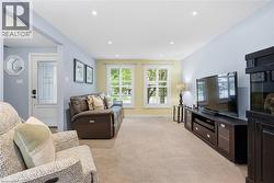 Spacious living area featuring neutral carpeting and recessed lighting - 