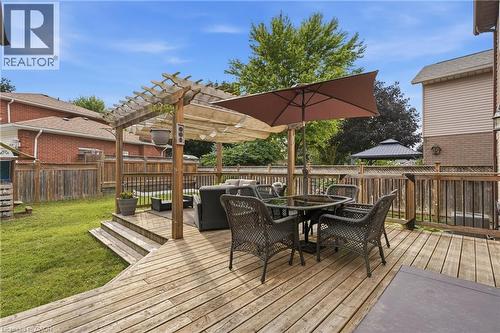 Multi-level wood deck featuring a pergola, wood railings, and stairs leading to a grassy yard - 19 Alona Avenue, Cambridge, ON - Outdoor With Deck Patio Veranda With Exterior