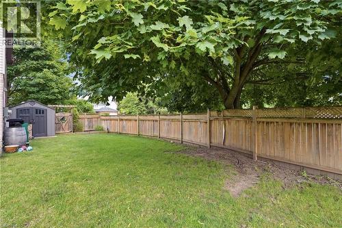 Expansive green lawn framed by a substantial wood privacy fence, featuring a decorative lattice top - 19 Alona Avenue, Cambridge, ON - Outdoor