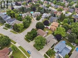 Aerial view of a residential neighborhood with established homes and mature trees - 