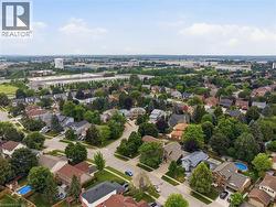 Aerial perspective showcasing a residential area with varied housing styles and mature tree coverage - 