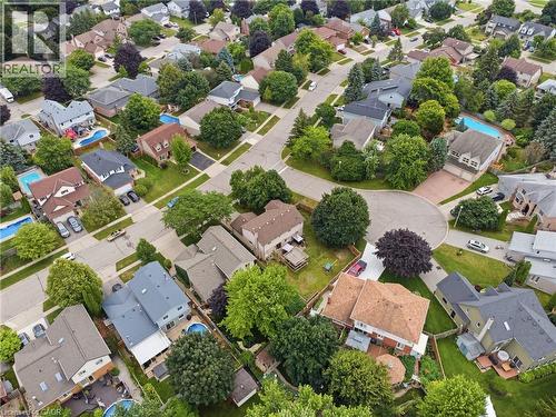 Residential neighborhood featuring a cul-de-sac, mature trees, and multiple properties with private swimming pools - 19 Alona Avenue, Cambridge, ON - Outdoor With View