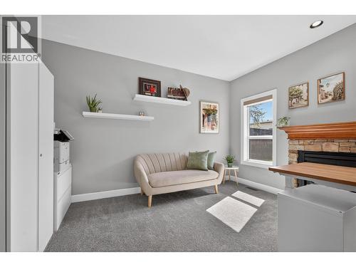 office - 4588 Raymer Road, Kelowna, BC - Indoor Photo Showing Living Room With Fireplace