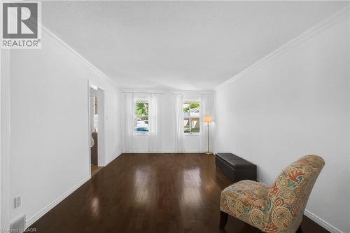 Spacious interior with dark wood-finish flooring, white walls, and crown molding - 123 Benn Drive, Cambridge, ON - Indoor Photo Showing Other Room