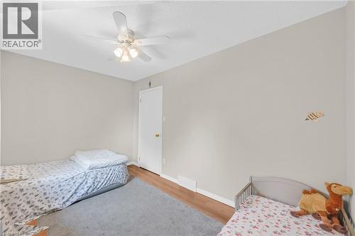 Neutral wall color with a ceiling fan light fixture - 123 Benn Drive, Cambridge, ON - Indoor Photo Showing Bedroom