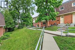 Brick exterior townhome with a gambrel roof and dormer windows - 