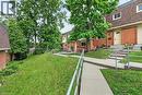 Brick exterior townhome with a gambrel roof and dormer windows - 125 Bonaventure Drive Unit# 50, Hamilton, ON  - Outdoor With Exterior 