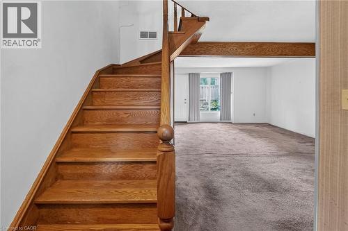 Hardwood staircase with turned newel post and balustrade - 125 Bonaventure Drive Unit# 50, Hamilton, ON - Indoor Photo Showing Other Room