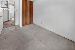 Light gray carpeted flooring paired with white walls - 