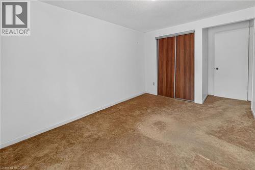 Room with neutral wall paint and textured brown carpeting - 125 Bonaventure Drive Unit# 50, Hamilton, ON - Indoor Photo Showing Other Room