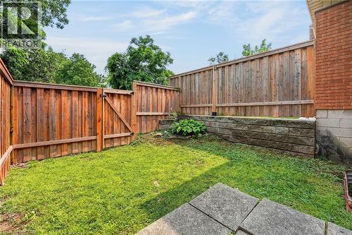 Private backyard with wood privacy fencing and a secure gate - 125 Bonaventure Drive Unit# 50, Hamilton, ON - Outdoor