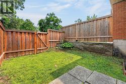 Private backyard with wood privacy fencing and a secure gate - 