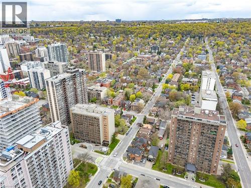 Aerial perspective showcasing a dense urban environment with a mix of residential buildings and extensive tree coverage - 199 Hunter Street W, Hamilton, ON - Outdoor With View