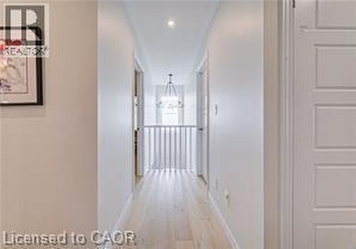 Hallway with light wood-finish flooring, recessed lighting, and white paneled doors - 290 William Street, Elmira, ON - Indoor Photo Showing Other Room