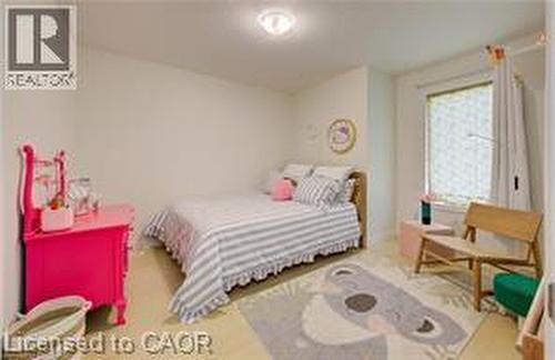 Bright room with light-toned flooring, a window offering natural light, and a ceiling-mounted light fixture - 290 William Street, Elmira, ON - Indoor Photo Showing Bedroom