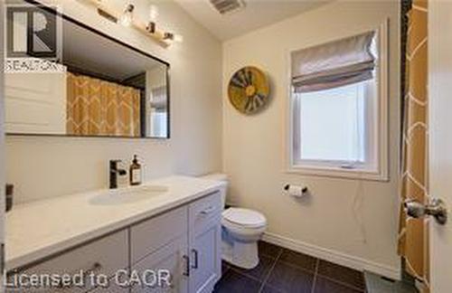 Bathroom featuring a single vanity with light-toned countertop, undermount sink, and matte black faucet - 290 William Street, Elmira, ON - Indoor Photo Showing Bathroom