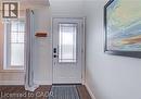 Entryway with wood-finish flooring, a white paneled door featuring a decorative glass insert, and an adjacent window with grid detailing - 290 William Street, Elmira, ON  - Indoor Photo Showing Other Room 