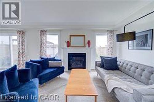 Living area featuring a white mantel fireplace, multiple windows with natural light, and light-toned wall finishes - 290 William Street, Elmira, ON - Indoor Photo Showing Living Room With Fireplace