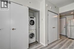 Dedicated laundry closet featuring a stackable washer and dryer, providing integrated utility - 