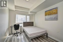 Room featuring large window, light wood-finish flooring, white baseboards, and neutral wall tones - 