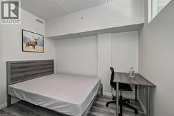 Bright room featuring light wood-finish flooring and a white ceiling - 