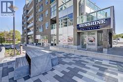 Commercial storefront featuring a prominent outdoor sign, large display windows, and a glass entrance door - 