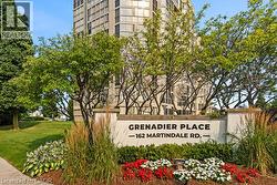 Stone monument signage featuring ""Grenadier Place"" and ""162 Martindale Rd."" with integrated landscaping - 