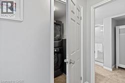 Integrated laundry closet featuring stacked appliances - 