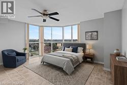 Bay window featuring multiple large panes, tile flooring, and a ceiling fan with integrated lighting - 