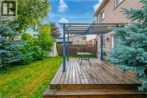 Wood deck with a pergola structure, offering an outdoor living area - 888 Paisley Road, Guelph, ON - Outdoor