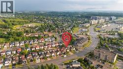 Aerial perspective showcasing a residential neighborhood with a mix of detached homes and multi-story buildings - 