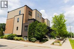 Contemporary multi-story exterior with a varied facade of brick and horizontal siding - 
