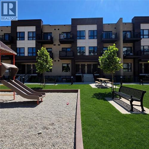 Modern multi-story building featuring brick and paneling facade - 20 Palace Place Unit# E9, Kitchener, ON - Outdoor With Balcony With Facade